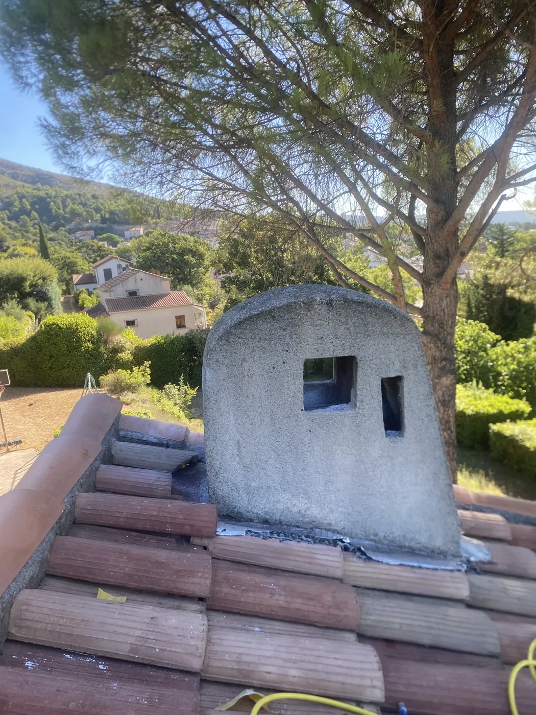 Souche de cheminée où nichaient des frelons, sur un toit à Trets